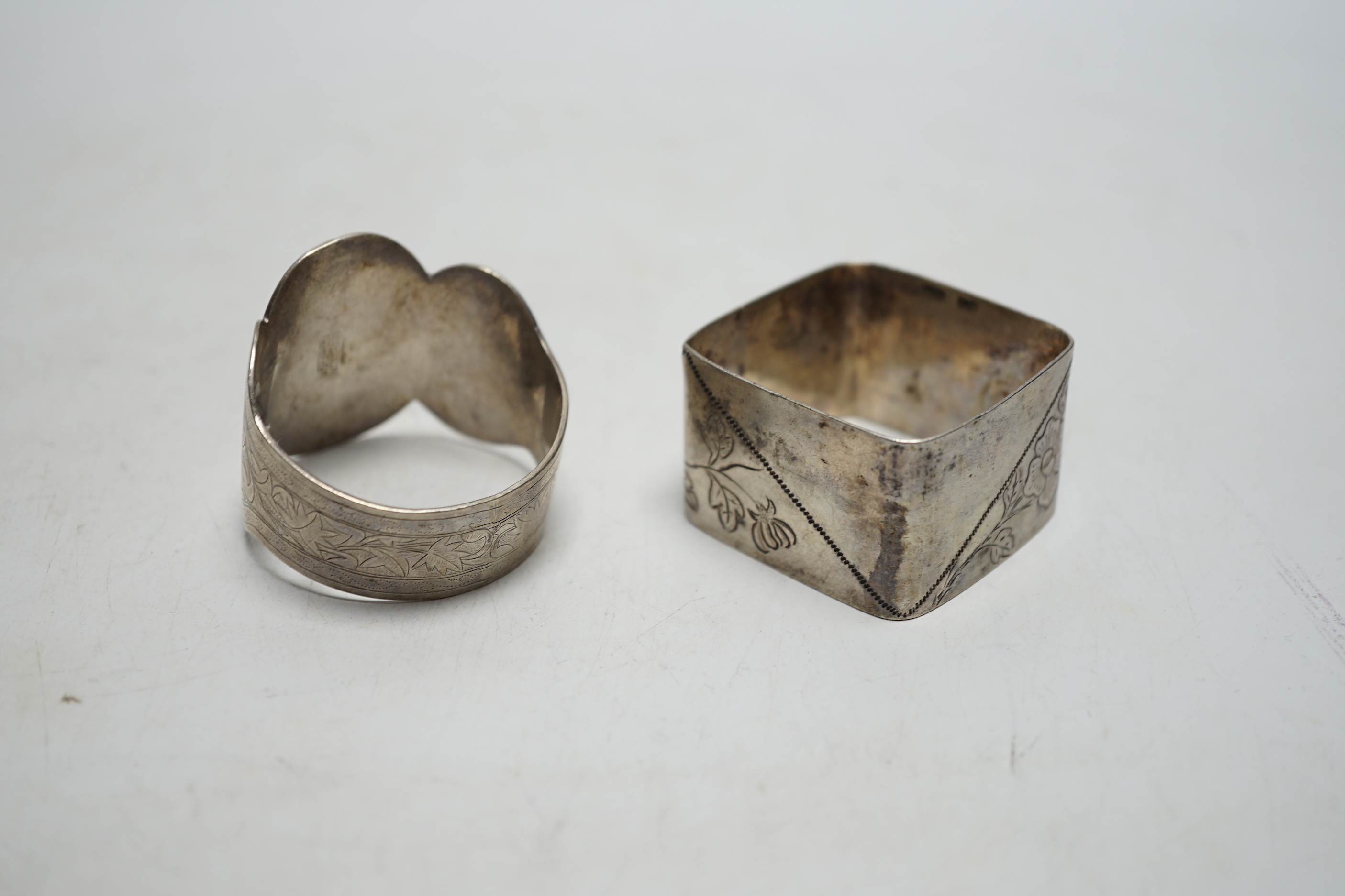 Two Chinese engraved white metal napkin rings.